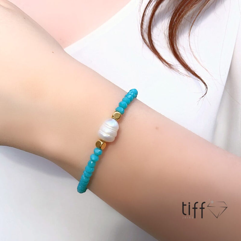 Pulseira cristais azul turquesa, pérola natural de água doce e detalhes em banho ouro 18k